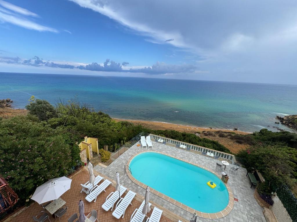 an overhead view of a swimming pool and the ocean at Casa Elvira in Isola Capo Rizzuto