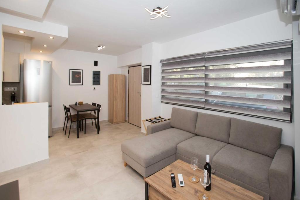a living room with a couch and a table at Ilissos Harmony Apartment in Piraeus