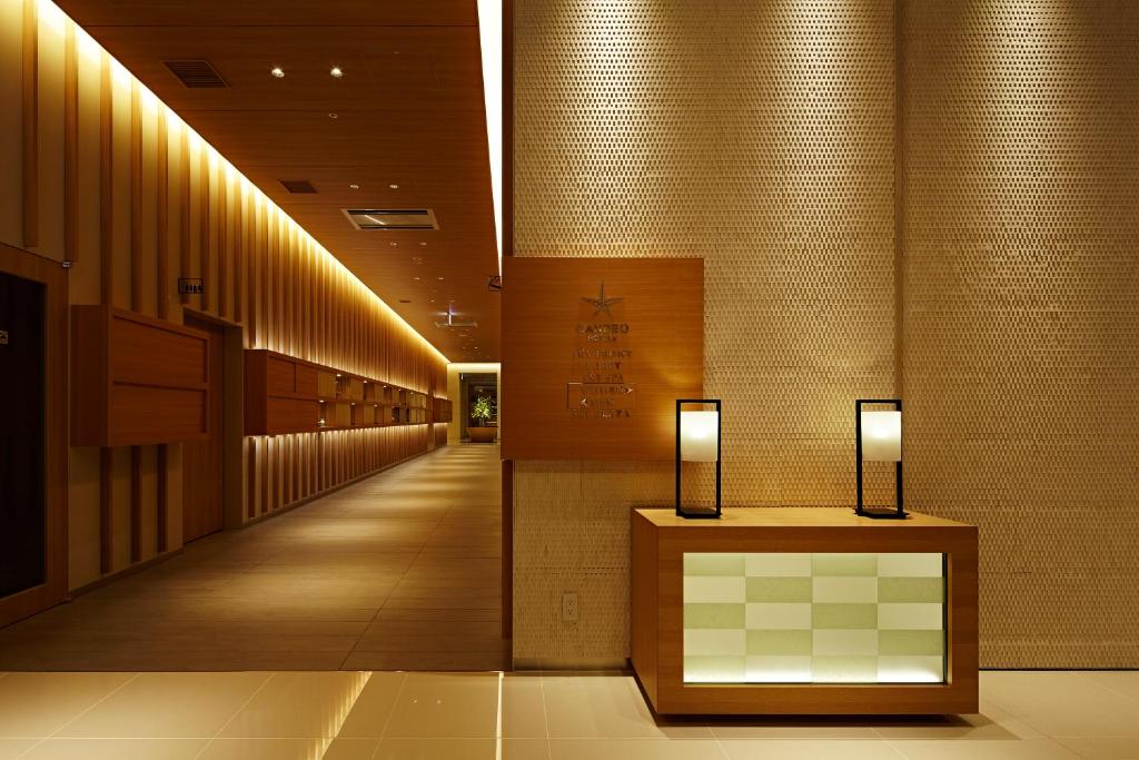 a hallway of a hospital with lights on the wall at Candeo Hotels Matsuyama Okaido in Matsuyama