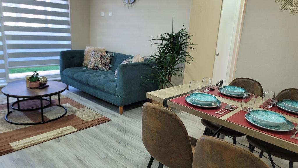 a living room with a table and a couch at Departamento nuevo y completo en Condominio Volcán Antuco in Los Ángeles