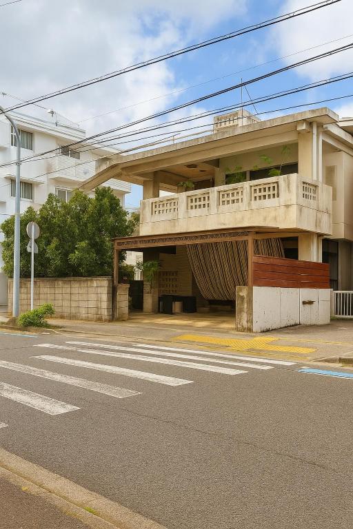 a building with a balcony on the side of a street at 沖縄やどや in Nago