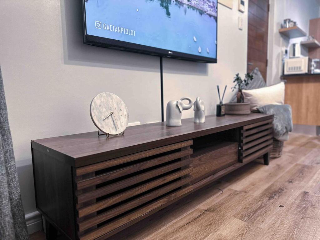 センチュリオンにあるA home away from home cosy luxurious compact 1 bedの壁にテレビが掛かっているリビングルーム