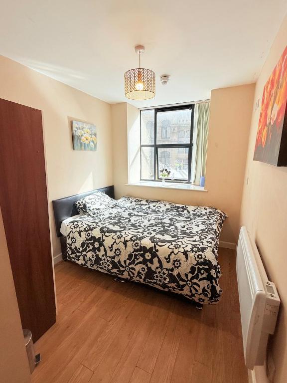 a bedroom with a bed and a window at Double Bed Apartment Bradford City Center in Bradford