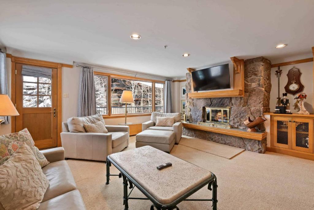 a living room with a couch and a fireplace at Lodge Tower 387 Three Bedroom Residence in Vail