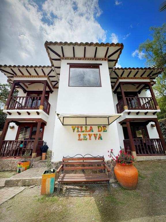 a building with a bench in front of it at Casa Hotel San Pedro in Villa de Leyva