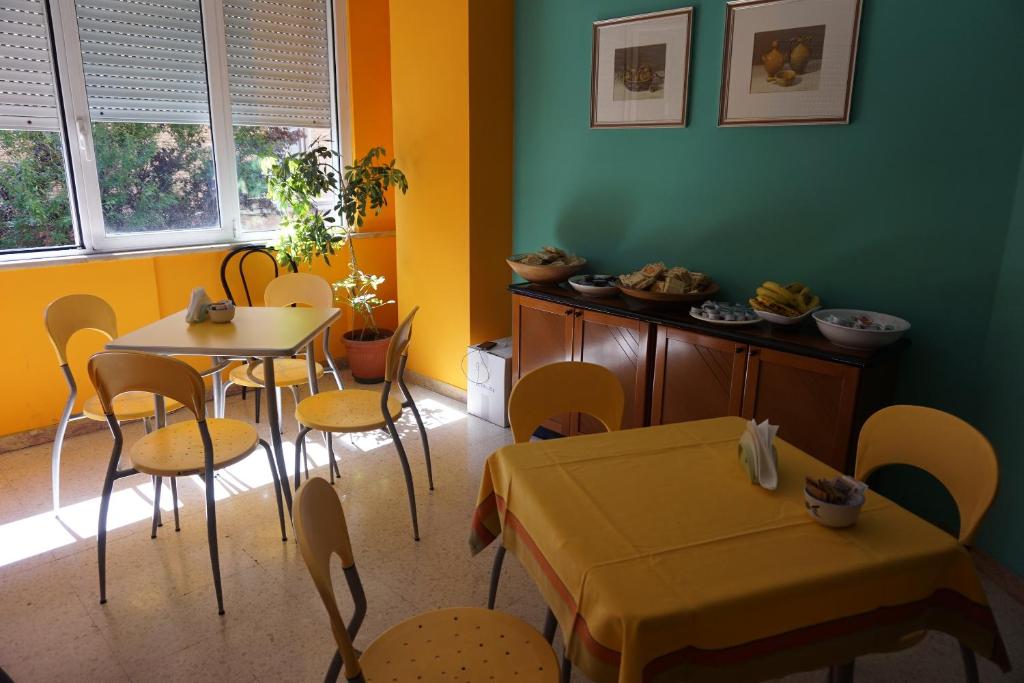 a dining room with two tables and chairs and a table at Hotel San Marco in Pesaro