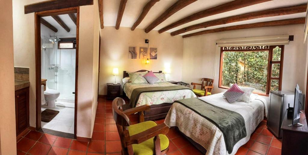 En eller flere senge i et værelse på Casa Hotel San Pedro