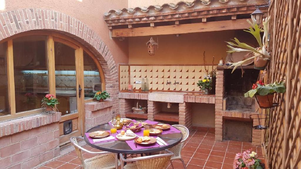 an outdoor patio with a table with food on it at Apartamento Casa Yaya al lado de Port Aventura in Vila-seca