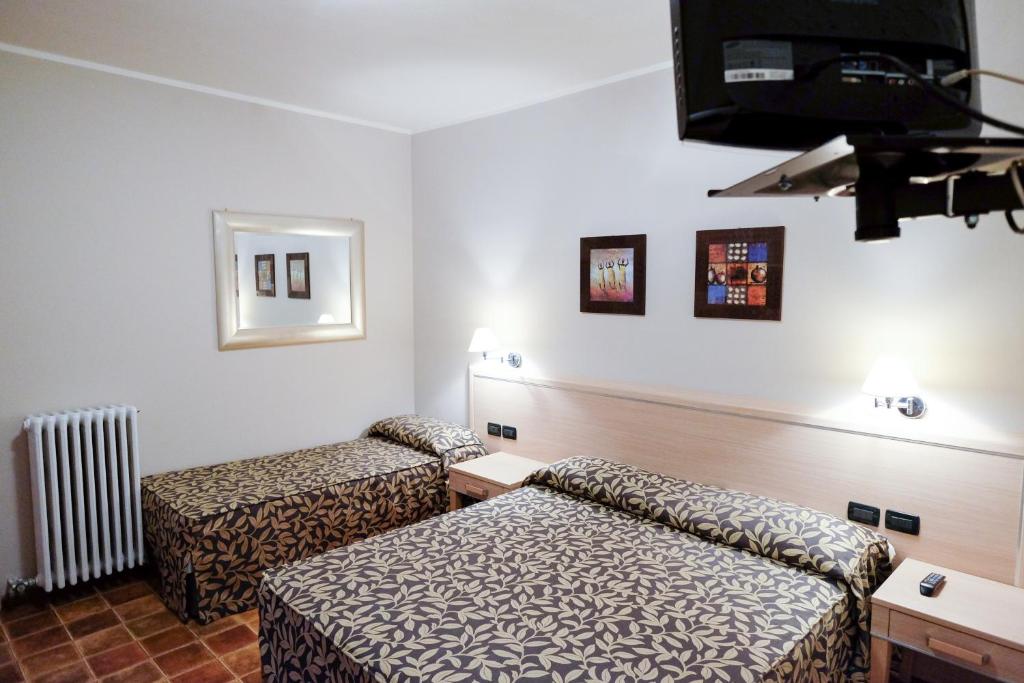 Postel nebo postele na pokoji v ubytování Hotel Monte Cimone
