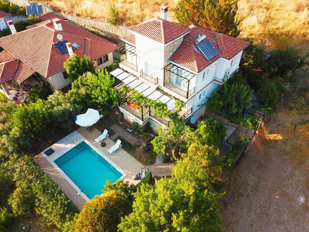 an aerial view of a house with a swimming pool at Villa Uzumlu in Fethiye