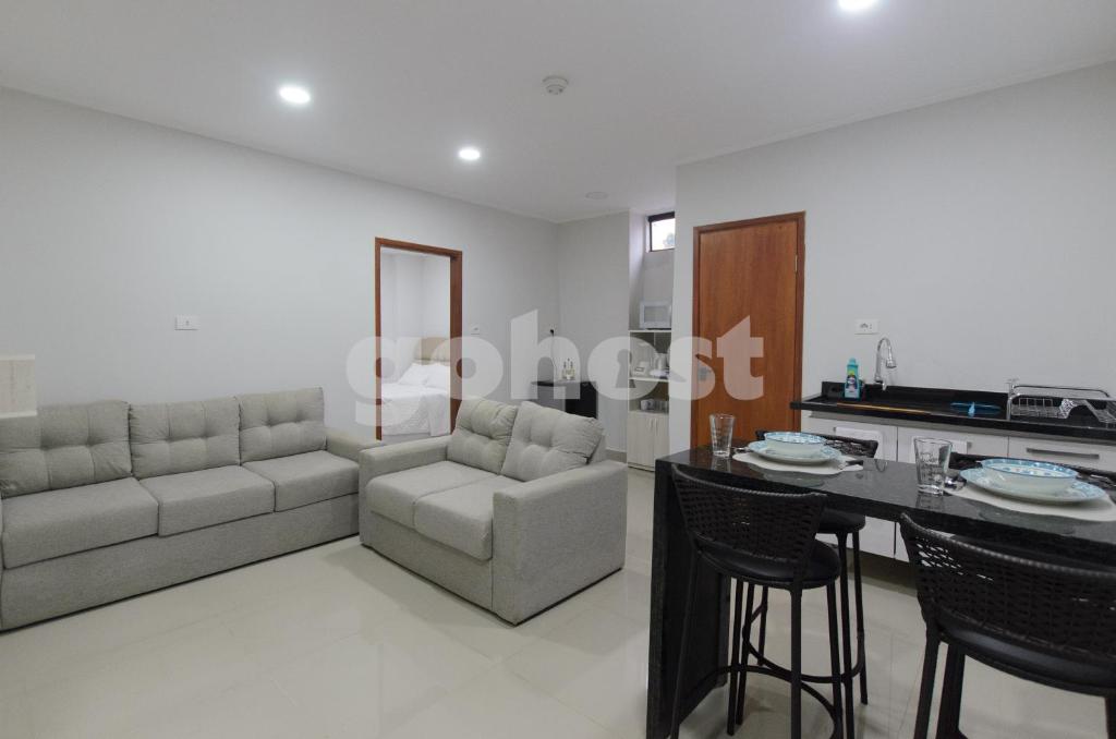 a kitchen and living room with a couch and a table at Comfortable 1 Br In The Center Of Ciudad Del Este in Ciudad del Este