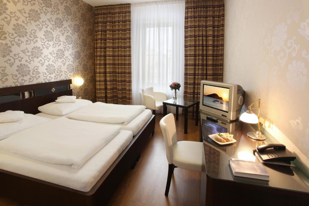 Postel nebo postele na pokoji v ubytování Hotel Trinity