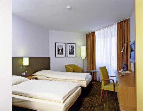 Кровать или кровати в номере Overnight Tagungshotel im ABZ