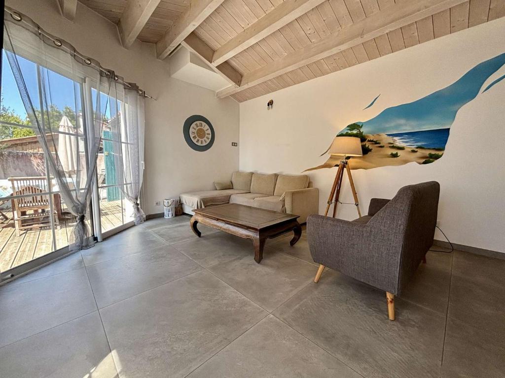 a living room with a couch and a table at Maison à Saint Denis d'Oléron - Jardin - 6 personnes - FR-1-246A-372 in Saint-Denis-dʼOléron
