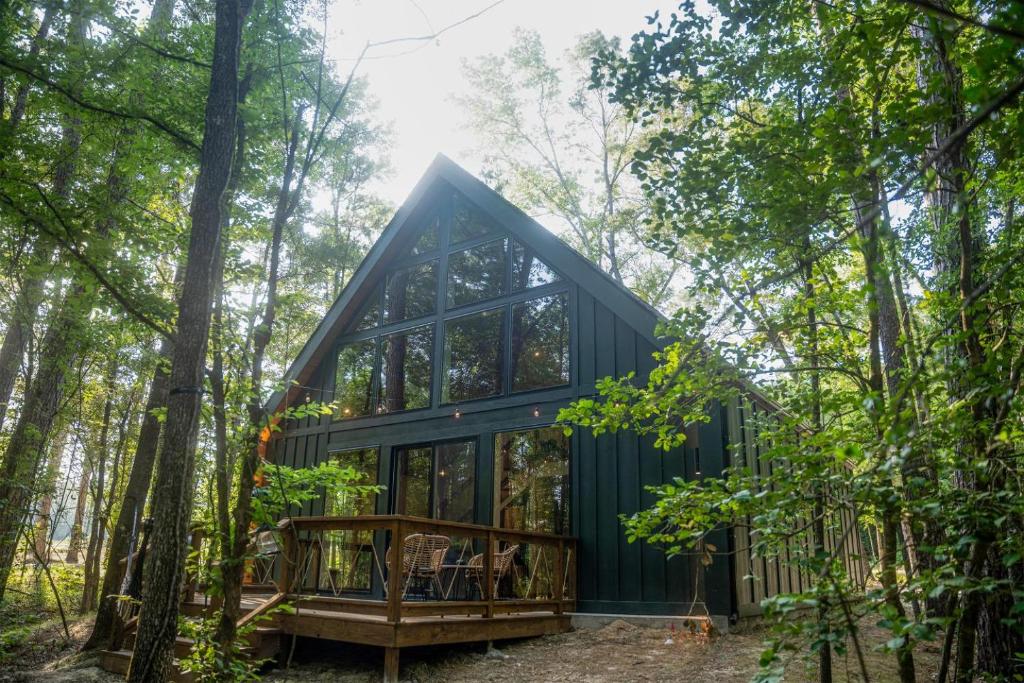 a cabin in the woods with a large window at LostForest Cabins in Richards