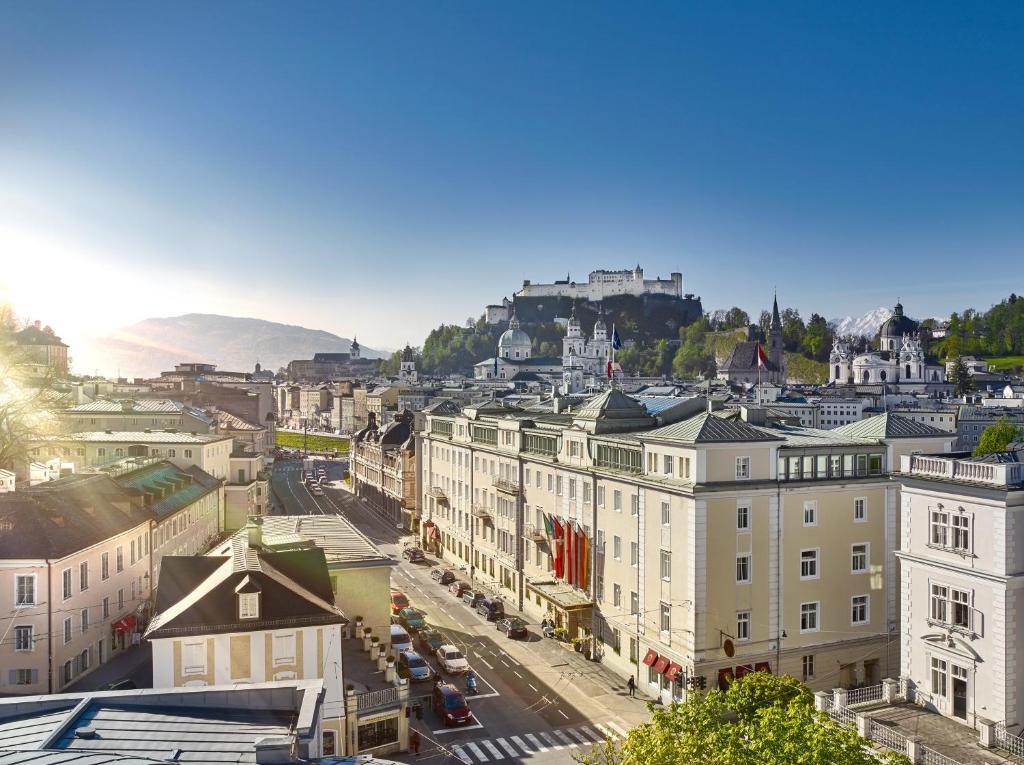 
a large building with a clock on the side of it at Hotel Sacher Salzburg in Salzburg
