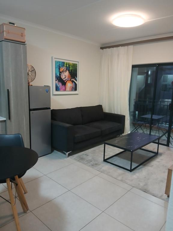 a living room with a couch and a table at The Aura in Northriding