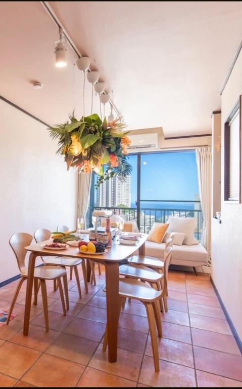 a dining room with a table and chairs and a couch at Cute&Resort熱海 in Atami