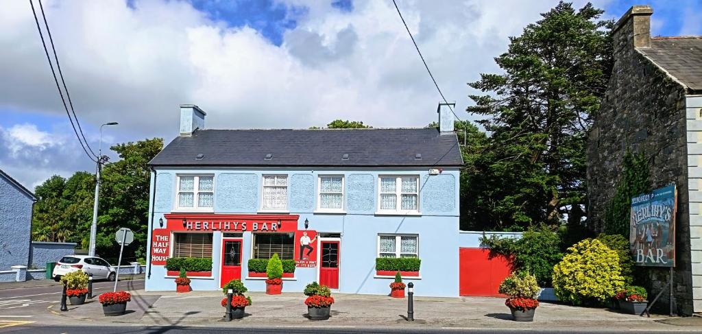 a model of a house with flowers in front of it at Herlihy's in Farranfore