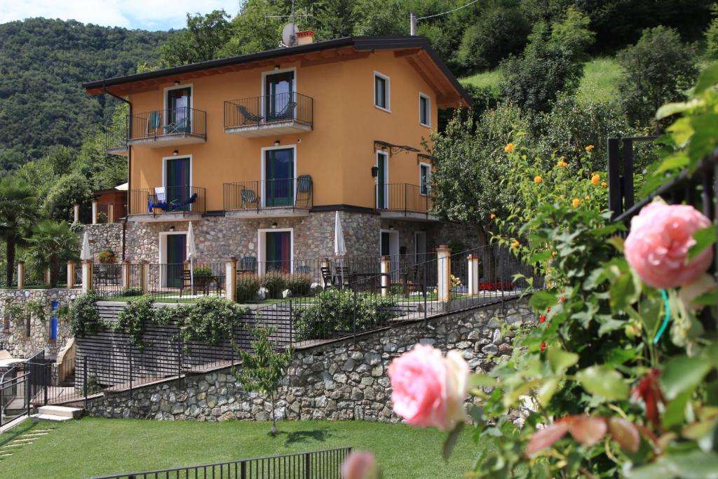 a house on a hill with a stone wall at Fenil Del Santo in Tremosine Sul Garda