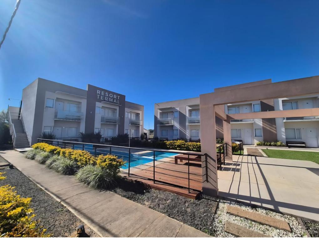 an apartment building with a swimming pool at Resort Termal Chajarí in Chajarí