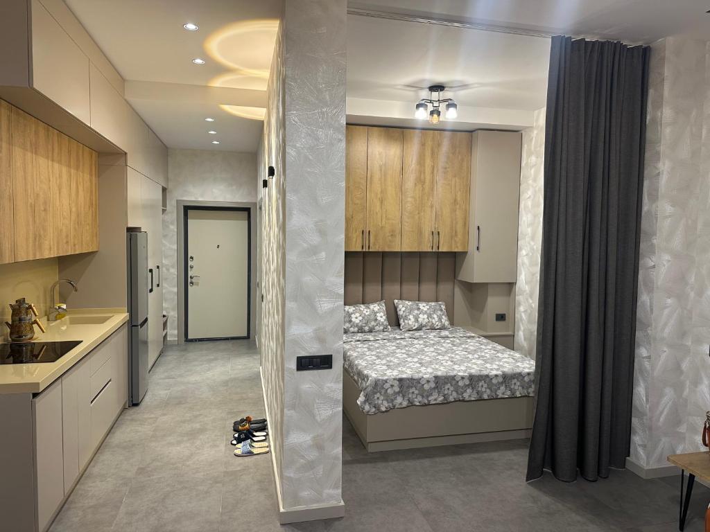 a kitchen and a bedroom with a bed in a room at Sea breeze Park residence 2 in Baku