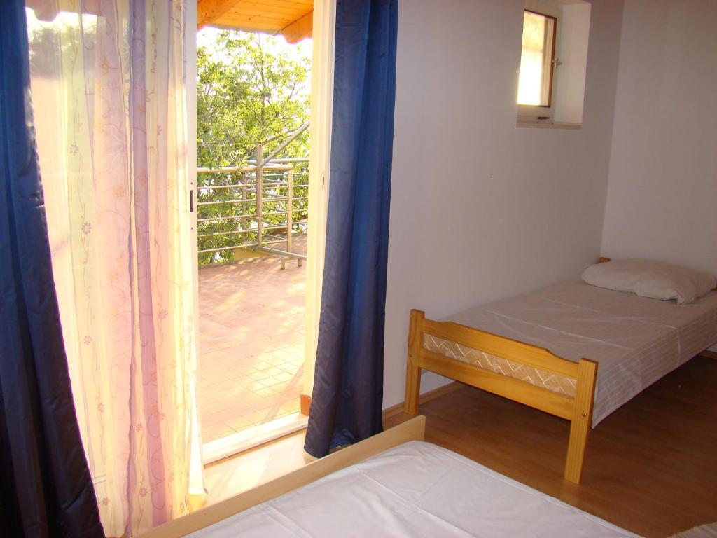 Posteľ alebo postele v izbe v ubytovaní Apartmani Lisak Ugrina
