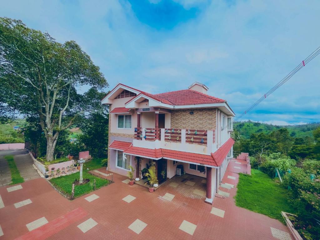 a small house with a red roof at Willostays Cloudhill ooty in Ooty