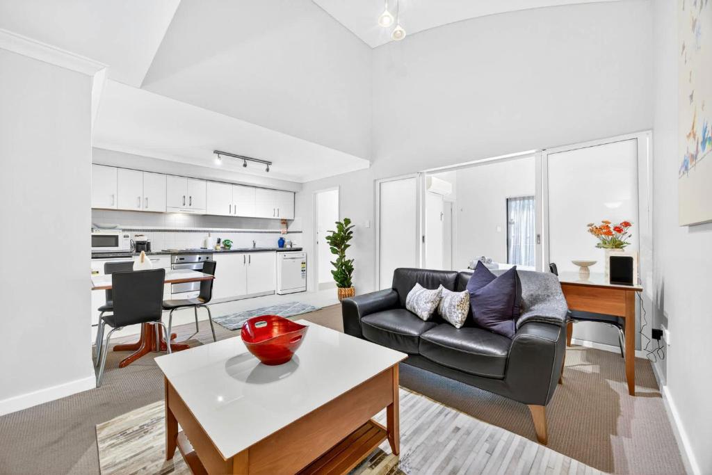 a living room with a couch and a table at Cloud Nine City Centre 1BDR in Perth