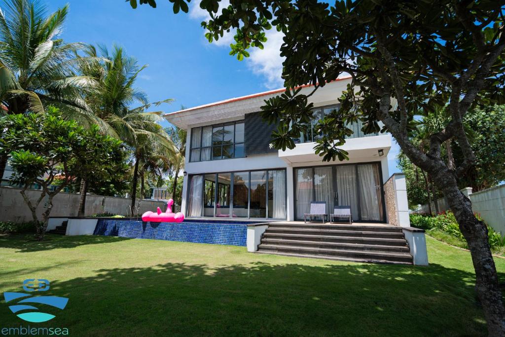 a house with a pink flamingo in the yard at Esea43 private pool villas in Danang