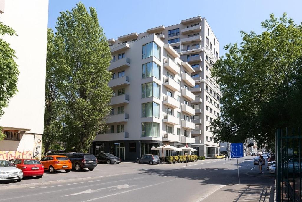 an apartment building on a street with parked cars at Central Suites in Bucharest