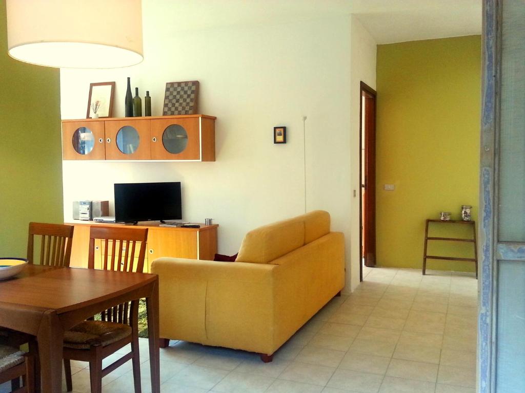 a living room with a couch and a table at Santa Caterina Apartment in Arluno