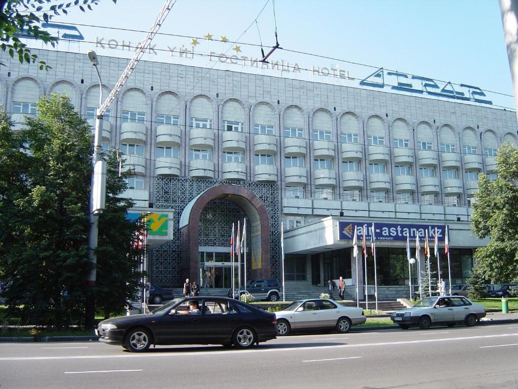 a large building with cars parked in front of it at Otrar in Almaty