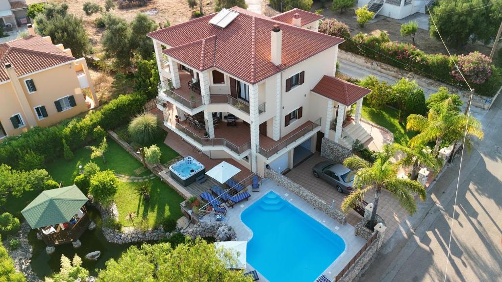 an aerial view of a house with a swimming pool at Villa Omega Kefalonia in Karavádhos