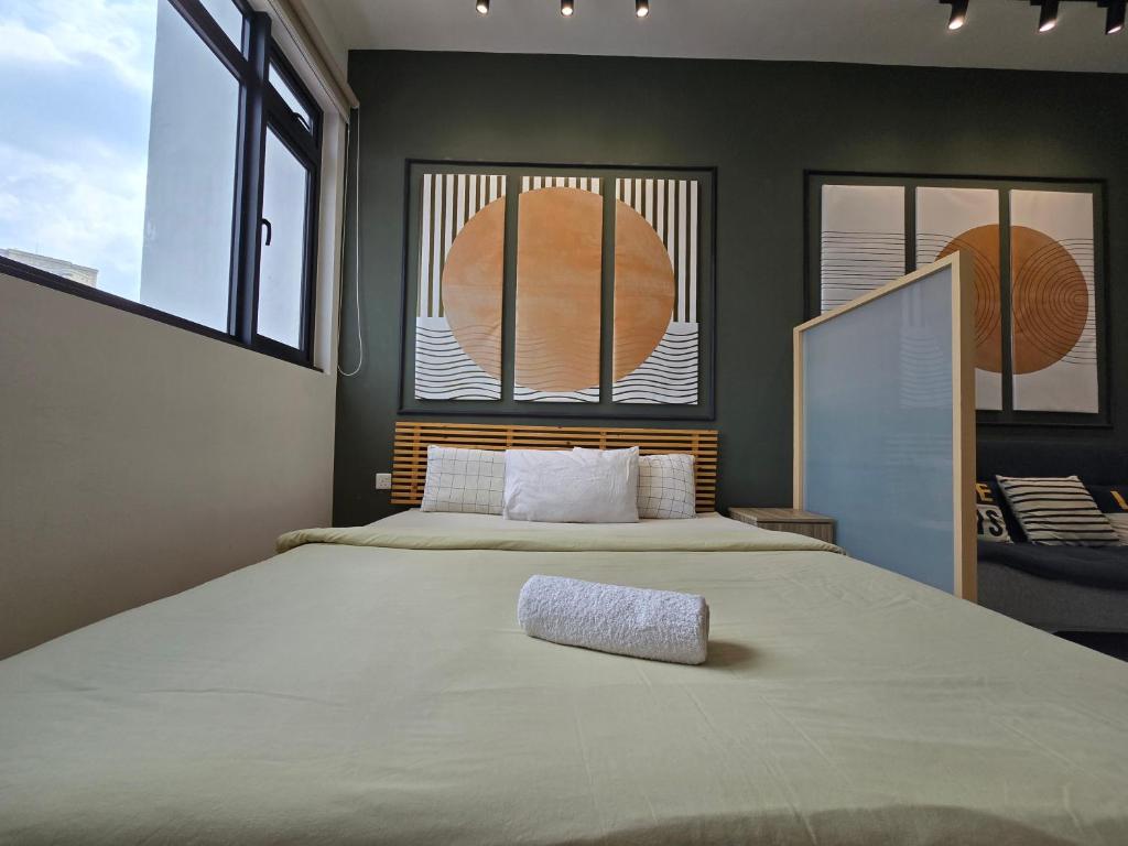 a bedroom with a large bed with a pillow on it at Chamber Residences KL At EZ Stay in Kuala Lumpur