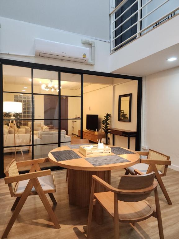a living room with a table and chairs at Super cozy new townhome in central of Bangkok 4 PAX in Ban Chek