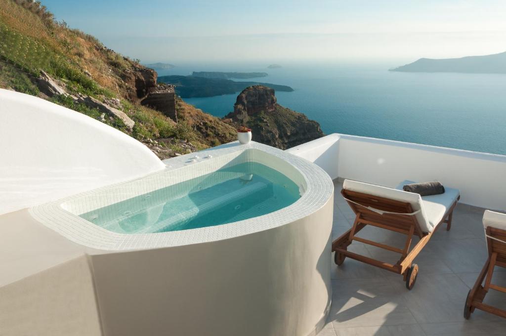 a jacuzzi tub on the side of a building at Caldera's Majesty in Imerovigli