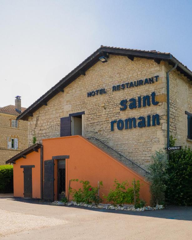 an orange building with a sign on the side of it at Logis Hôtel Restaurant Saint Romain in Anse