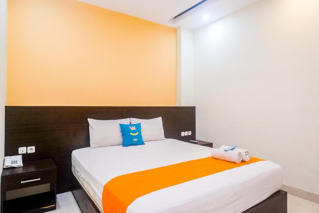 Postel nebo postele na pokoji v ubytování Sans Hotel Nagari Malioboro