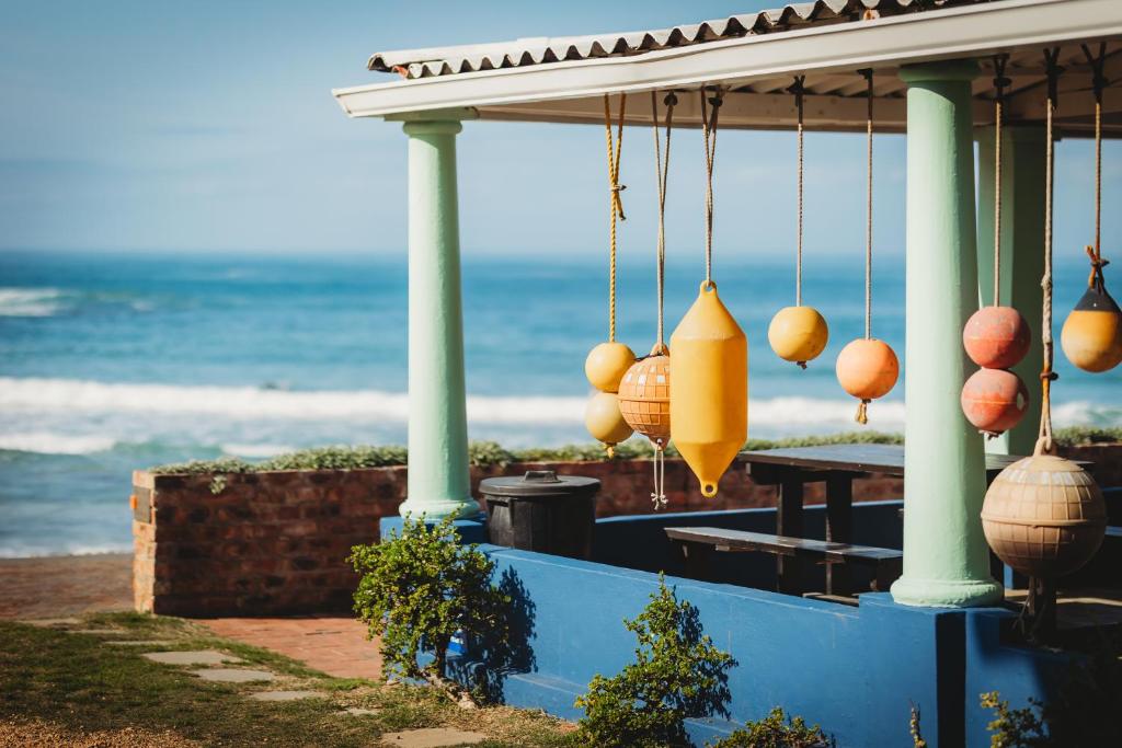 a porch with a view of the ocean at Silver Spray Beach Accommodation in Victoria Bay
