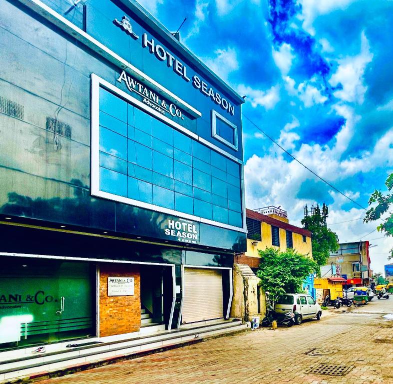 a building on the side of a street at Hotel Season in Ahmedabad