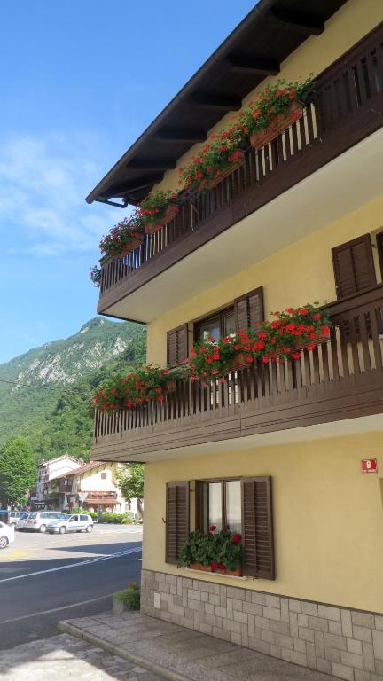 a building with flowers on the balconies on a street at Hisa Lescer in Kobarid