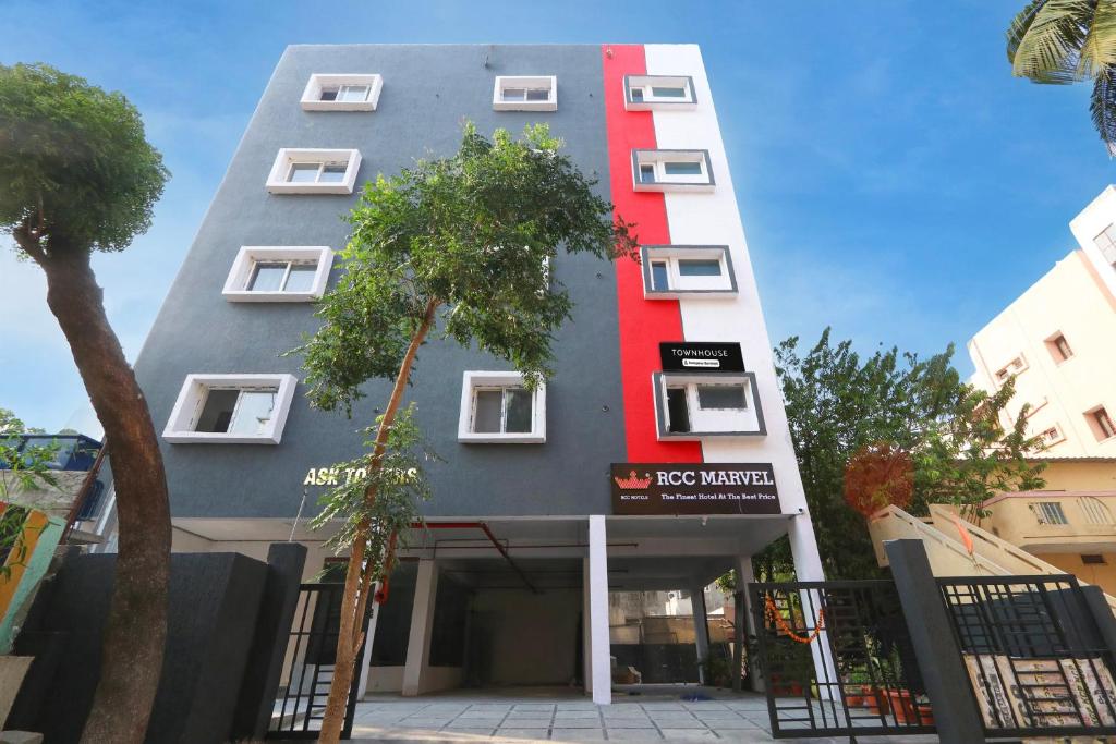 a building with a red stripe on the side of it at Super townhouse Dilshuk Nagar in Hyderabad