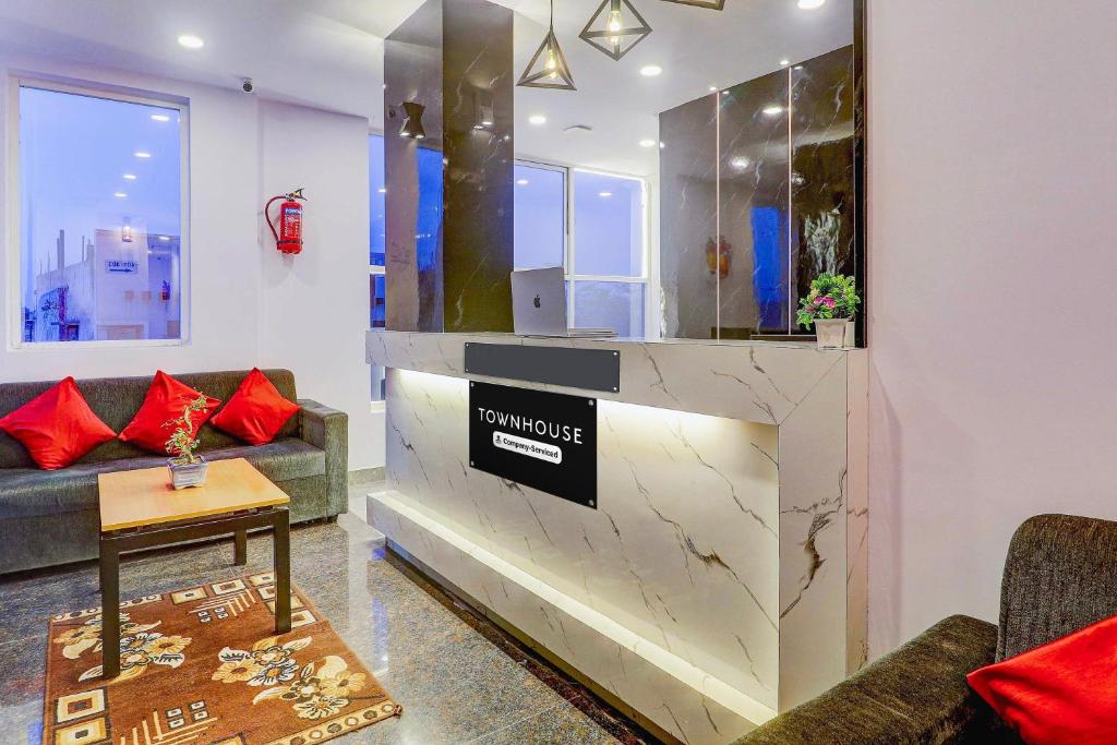 a living room with a lobby with a fireplace at Super Townhouse SR Nagar Near RCC Premier in Hyderabad