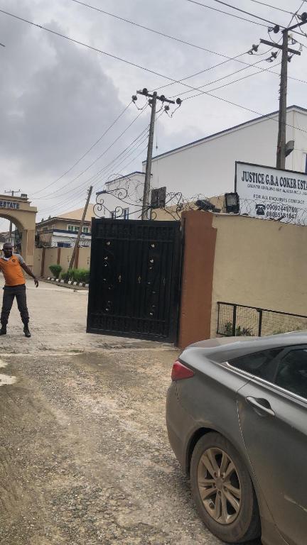 a car parked in front of a black gate at Qelifox apartment service in Lekki