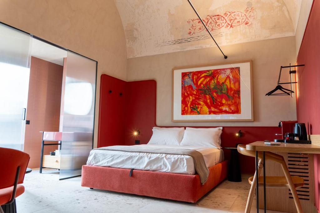 a bedroom with a large bed with a red headboard at Casa Tre Archi - Camere Luxury in Altamura