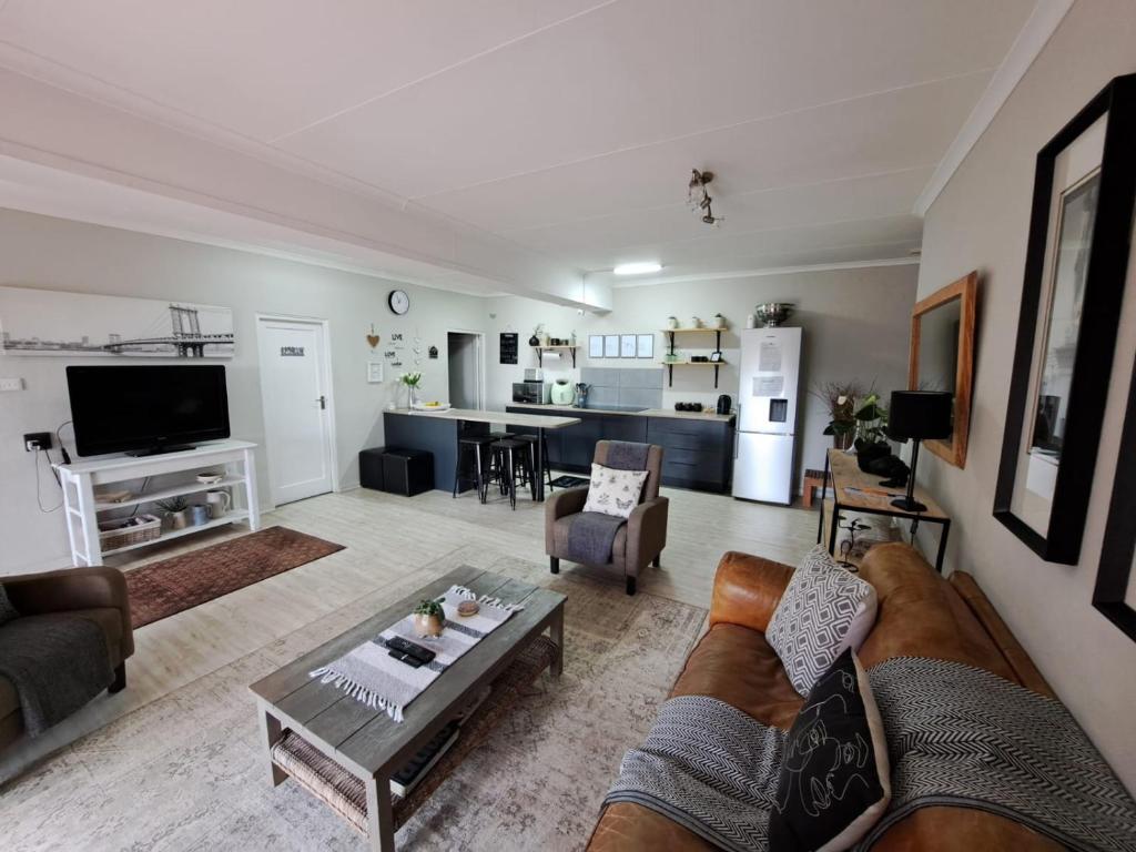a living room with a couch and a table at 258 on Aries in Pretoria
