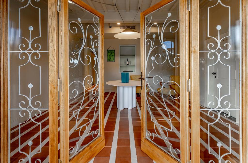 a hallway with wrought iron doors and a table at Cantina Semonte Wine Resort in Gubbio