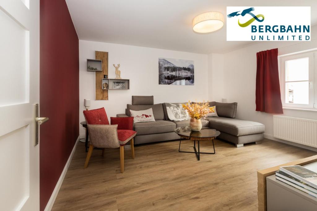 a living room with a couch and a table at Alpin Supreme in Oberstdorf
