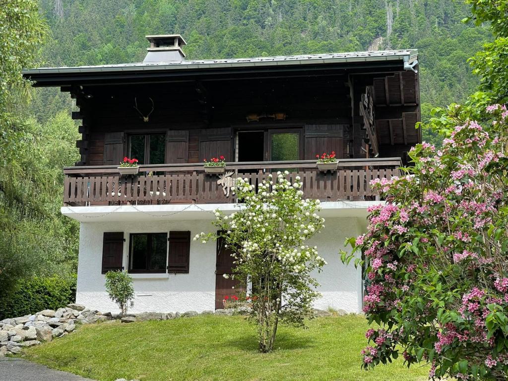 a house with a balcony with flowers on it at Peaceful ground floor apartment in Saint-Gervais-les-Bains
